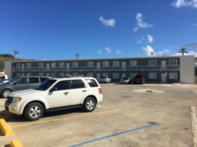a white car parked in front of a building