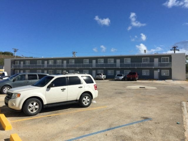a white car parked in front of a building