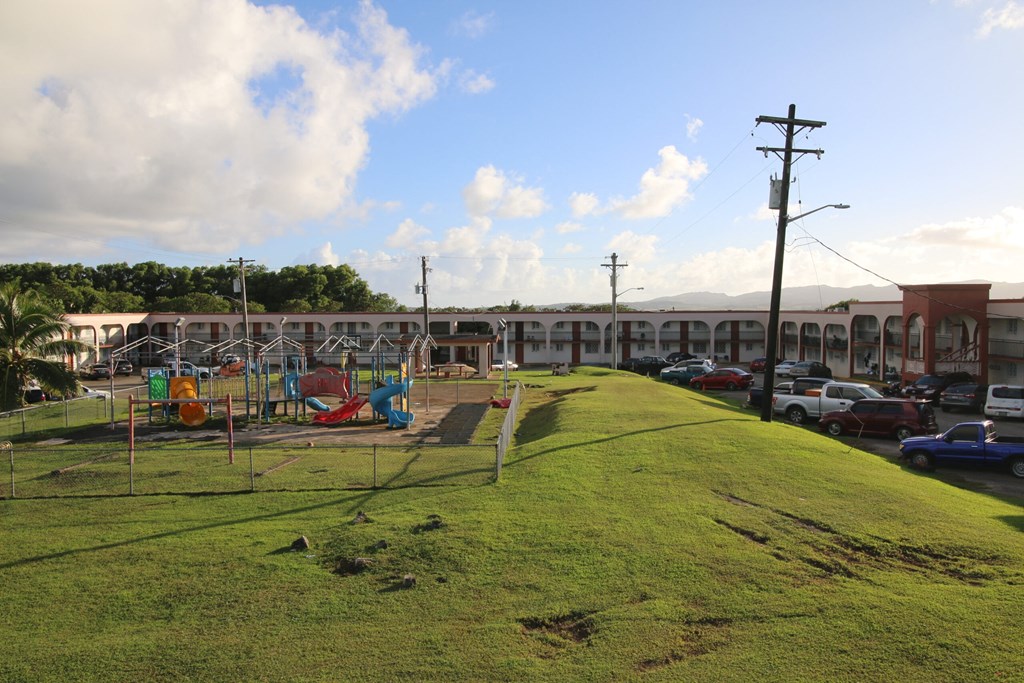 a playground in a park in front of a building