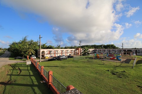 a view of a park with a playground and buildings