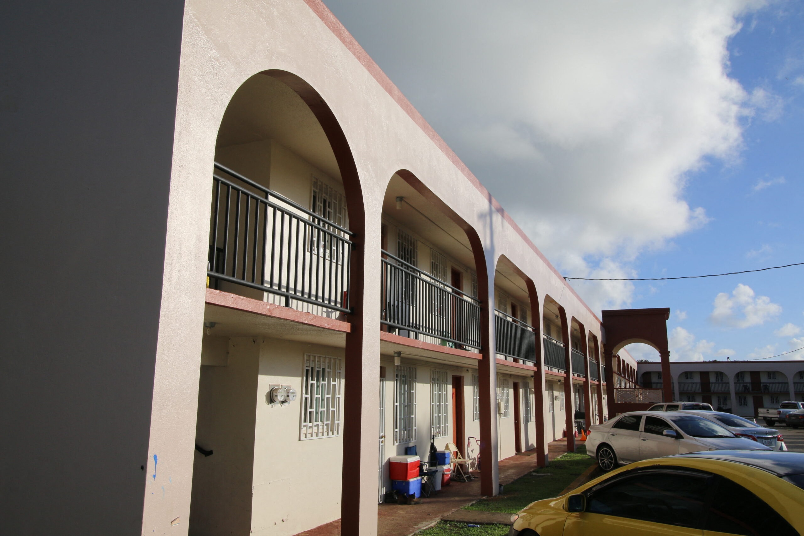 a row of buildings with cars parked in front of them