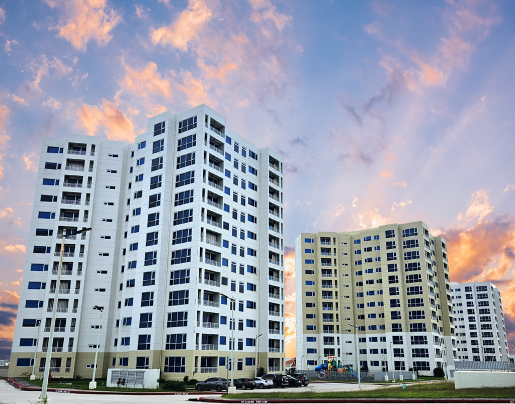 Two white buildings with balconies are in the foreground.