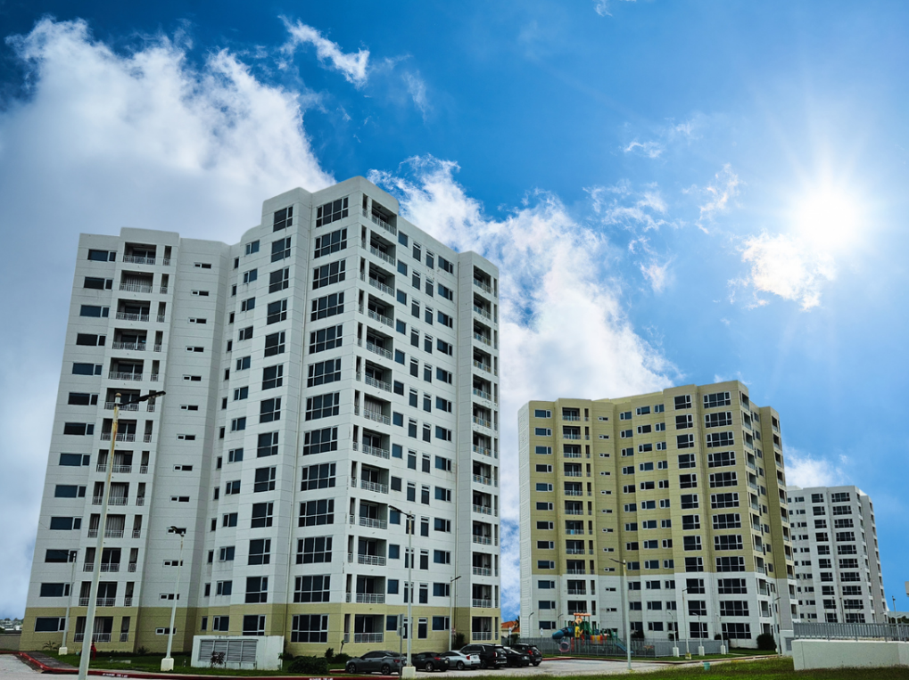 A large white building with a lot of windows is in the foreground.