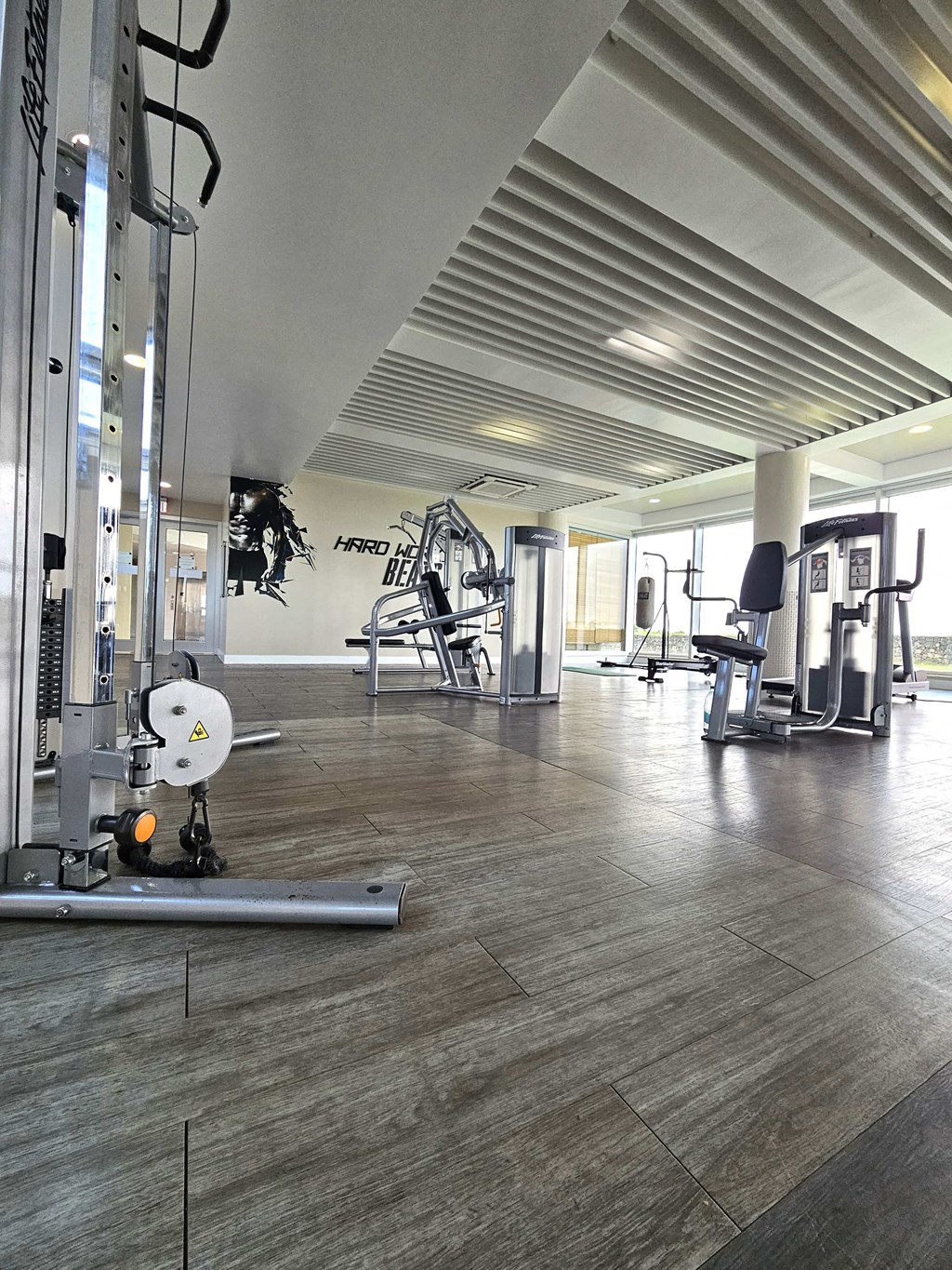 A gym with a variety of equipment including a weight bench and a squat rack.