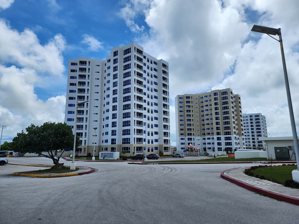 an empty parking lot in front of two tall buildings