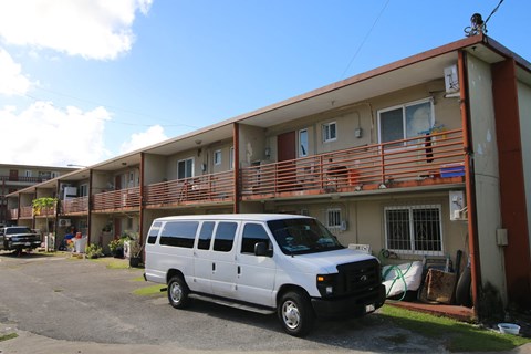 a white van parked in front of a building