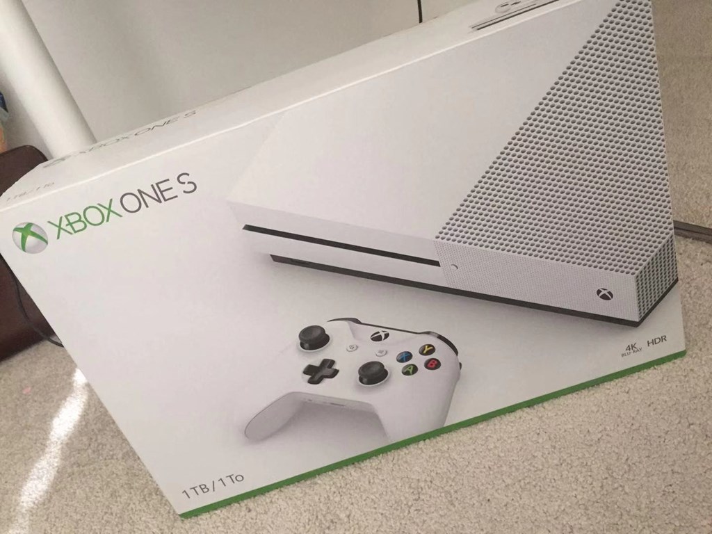 a nintendo wii game console and a controller on top of a box