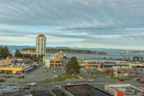 a view of the city and the water from a high rise building