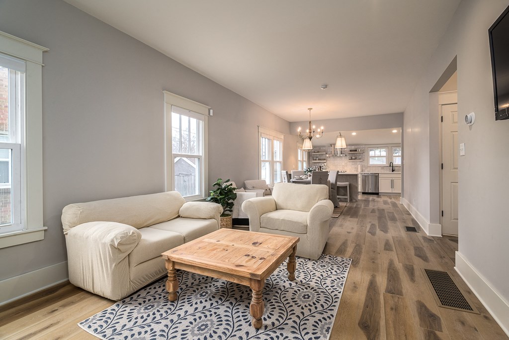 a living room with two white couches and a coffee table
