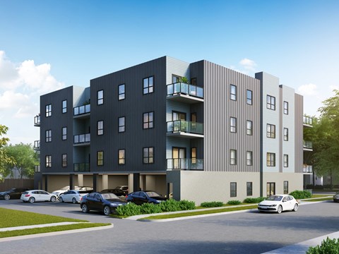 A modern apartment building with cars parked in front.