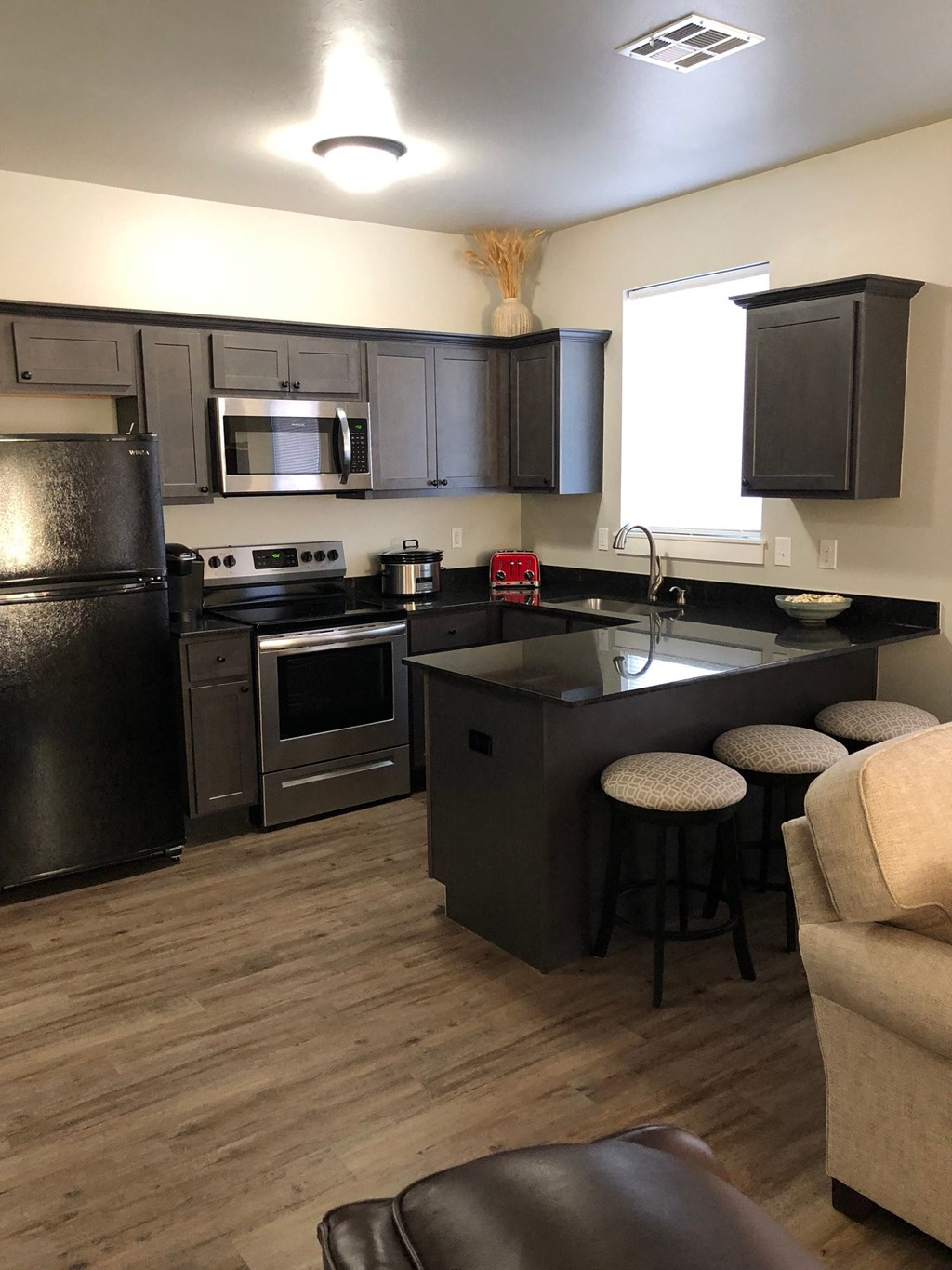 a kitchen with a center island and stainless steel appliances