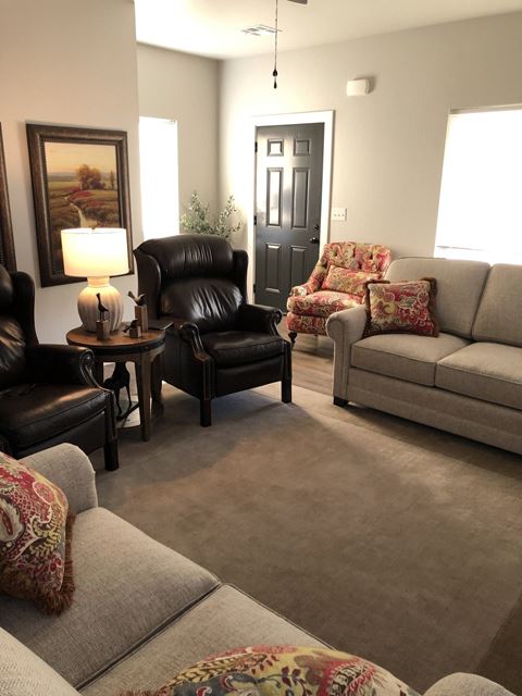 a living room with couches and chairs
