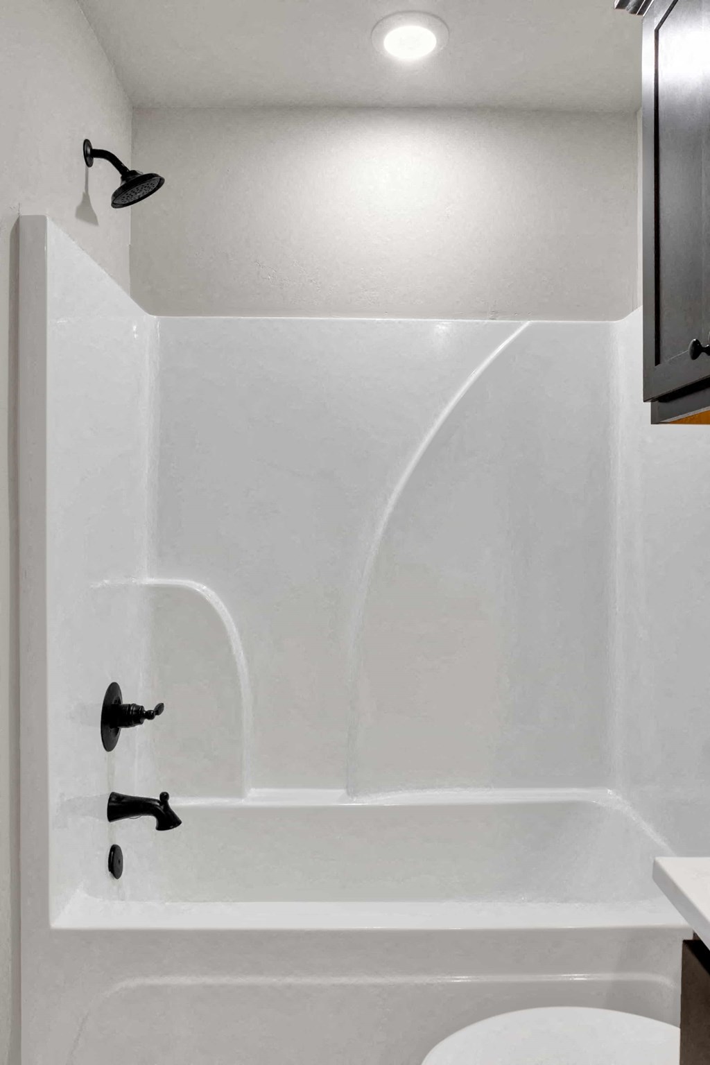 a white bathroom with a tub and a sink