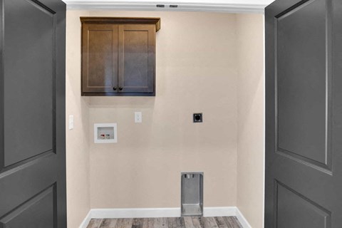 a room with a wall with a cabinet and a door