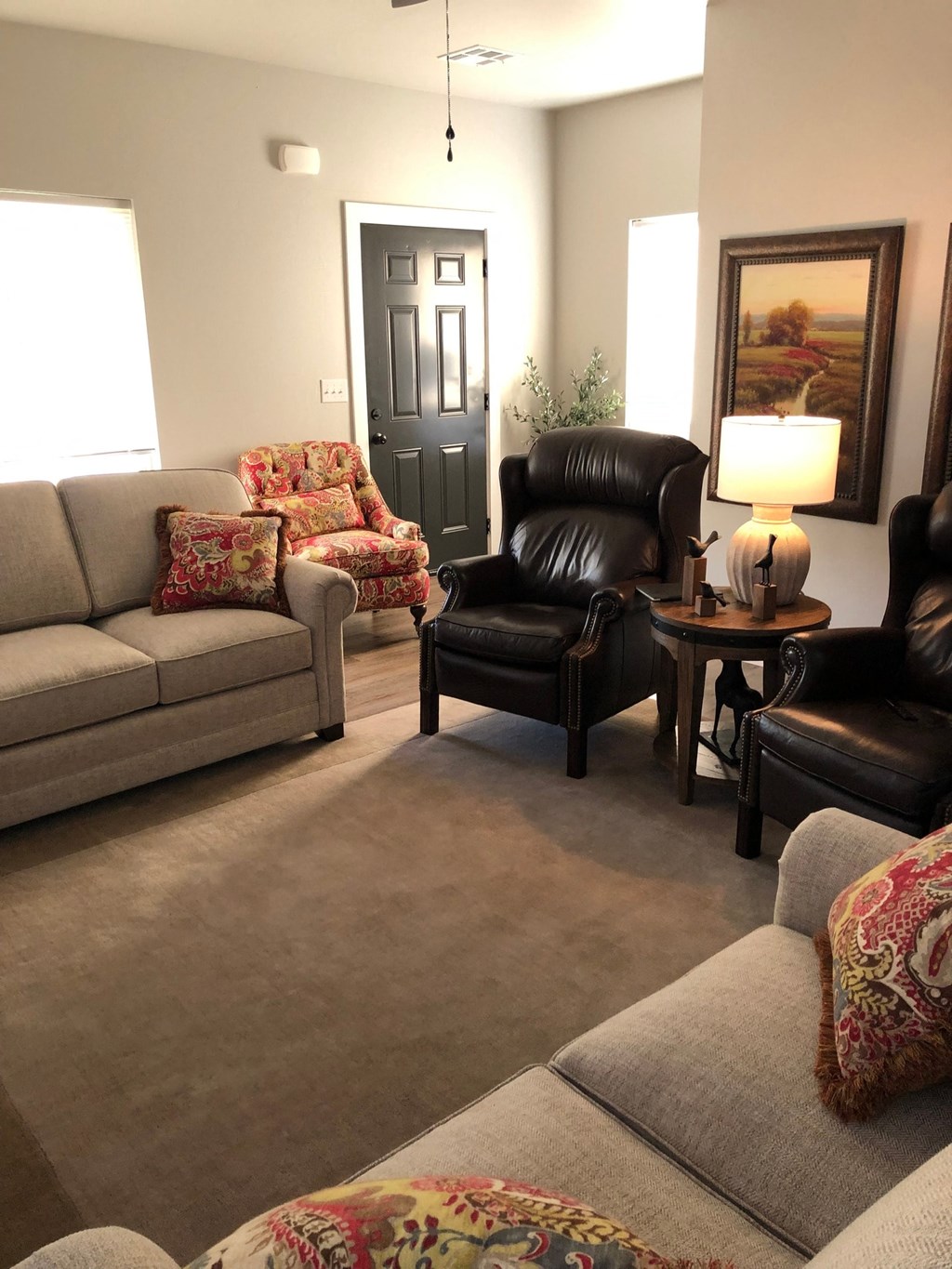 a living room with couches chairs and a table