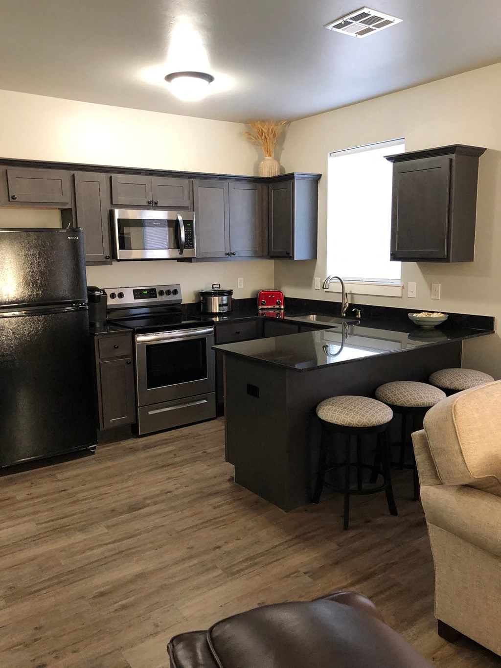a kitchen with a center island and stainless steel appliances