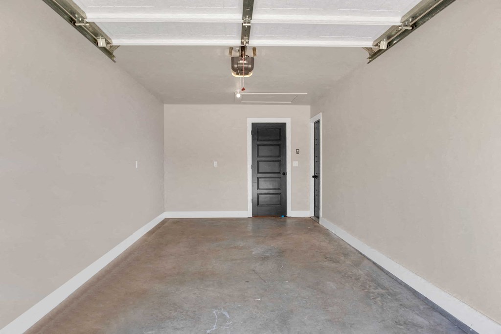 a empty room with a black door and white walls
