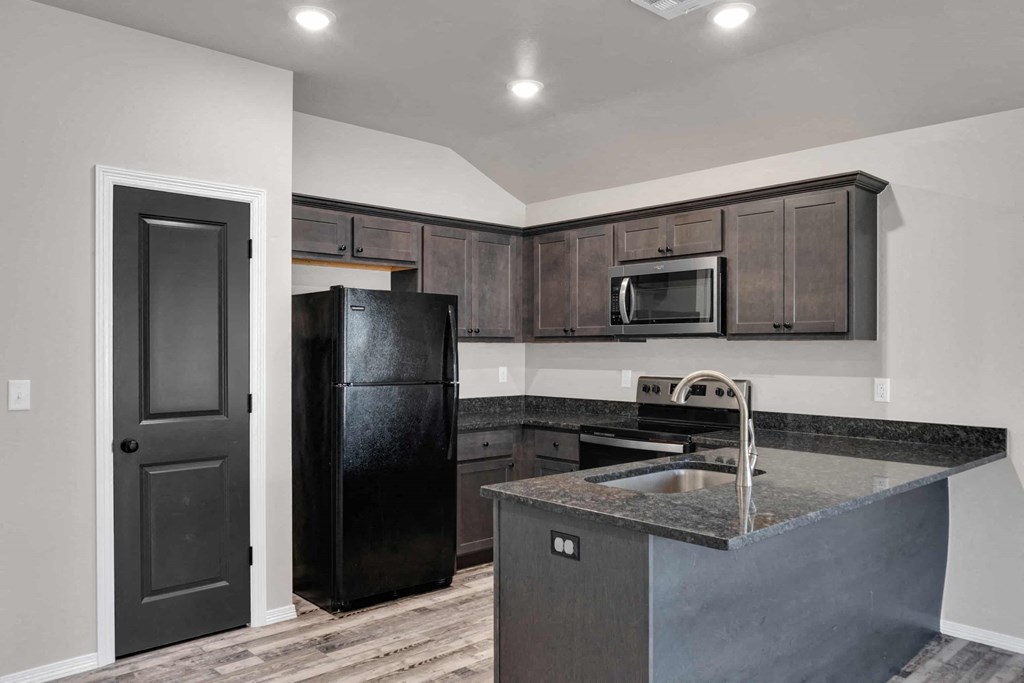 a kitchen with a sink and a refrigerator
