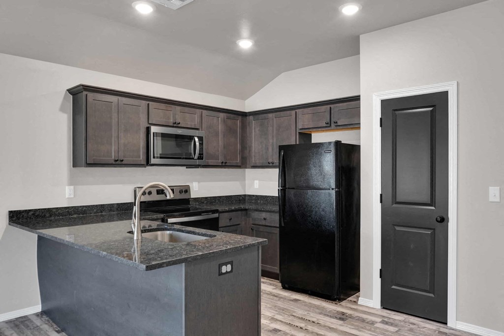 a kitchen with a sink and a refrigerator