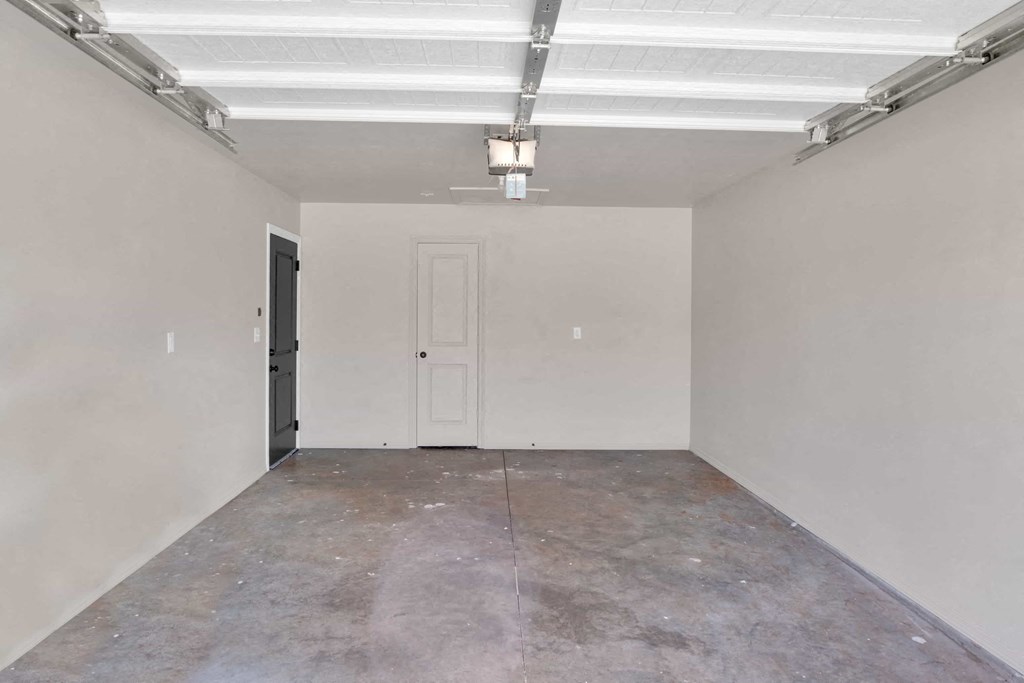 an empty room with white walls and a door