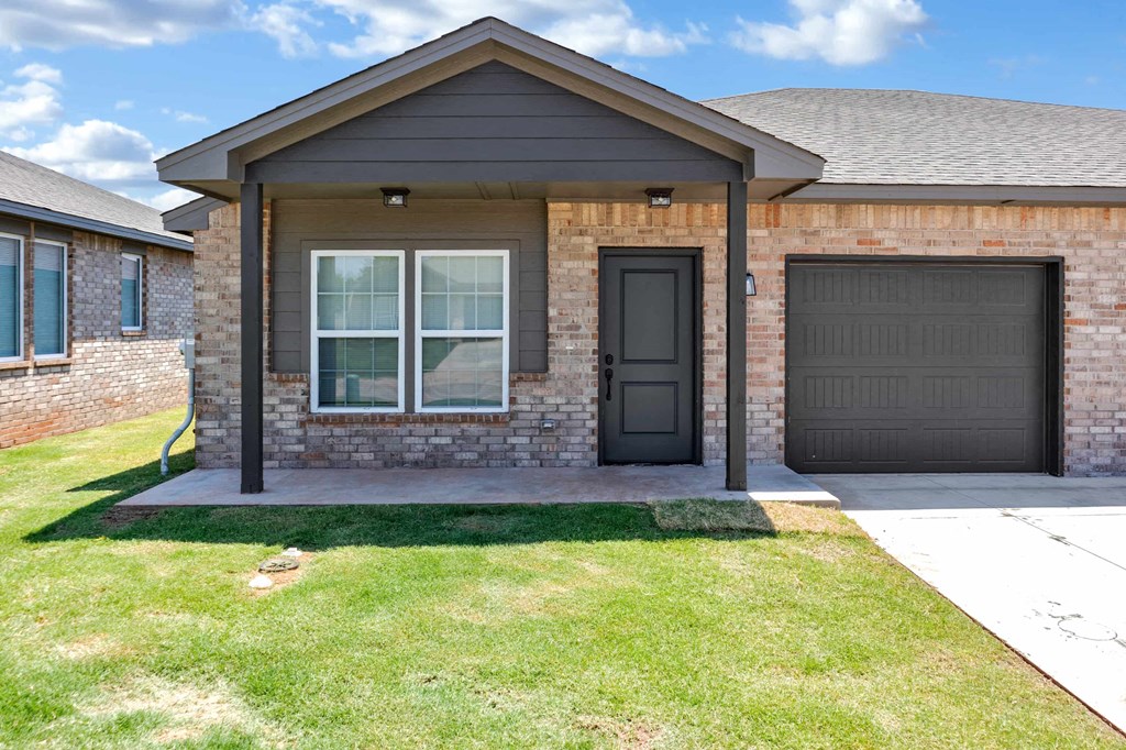 a house with a front porch and a black door
