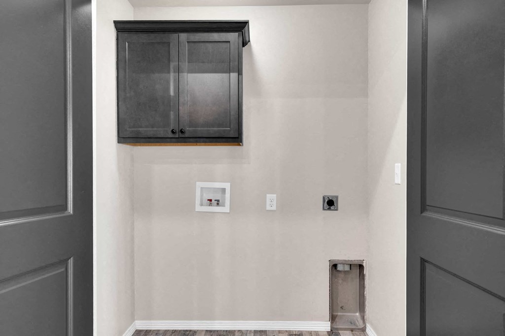 a wall with a medicine cabinet and two outlets and a door