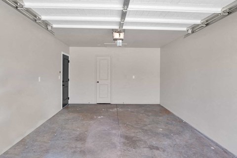 an empty room with white walls and a door
