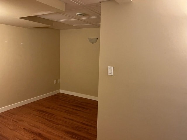 an empty room with a wood floor and a ceiling fan