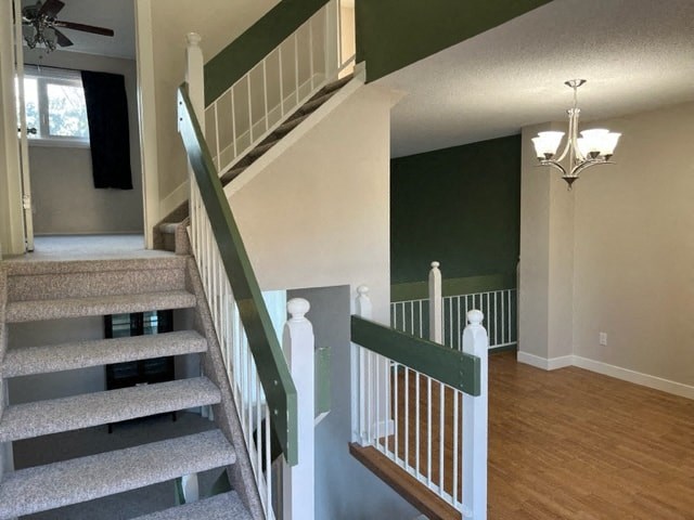 a staircase in a house with a green wall and wood floors