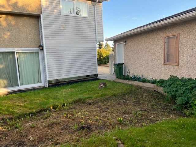 a backyard with a house and a yard with grass