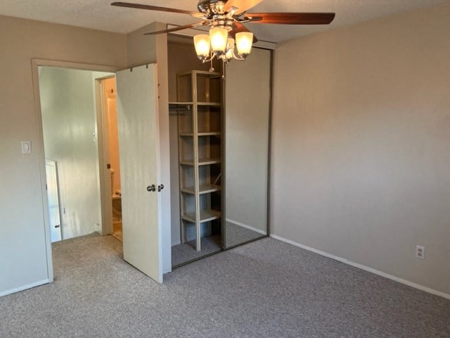 an empty room with a closet and a ceiling fan