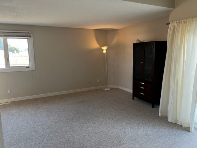 a living room with a dresser and a window