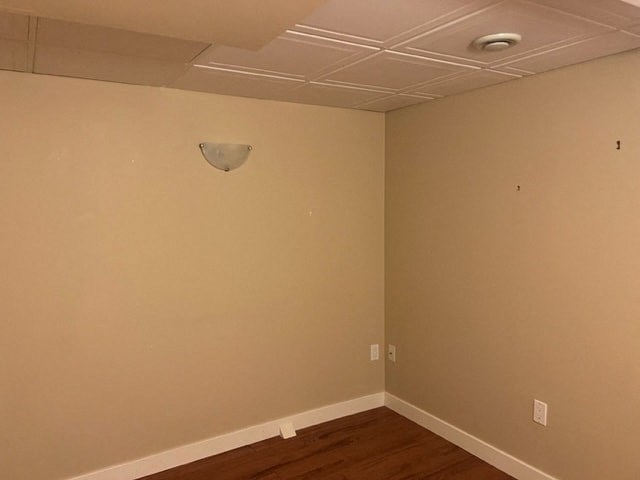 an empty room with a lamp on the wall