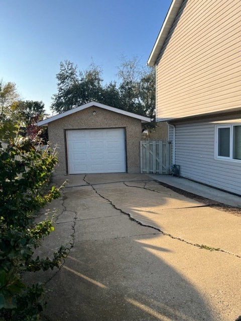 a driveway in front of a house with a white garage door