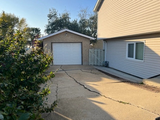 a white house with a driveway and a white garage door