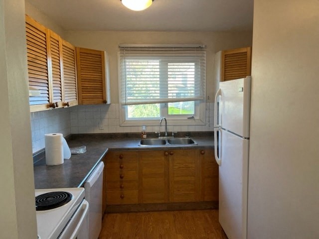 a kitchen with a stove and a sink and a refrigerator