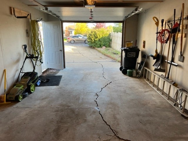 a driveway with a crack in the floor of a garage