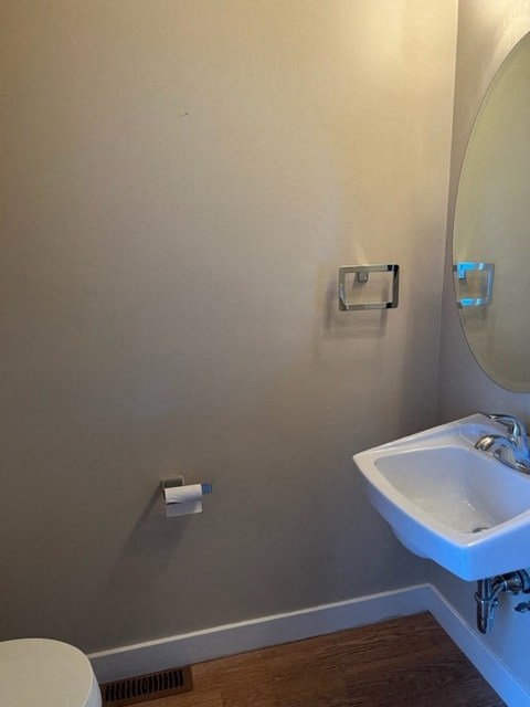 a bathroom with a sink and a mirror and a toilet