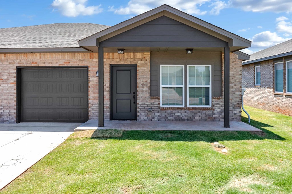a house with a front porch and a black door