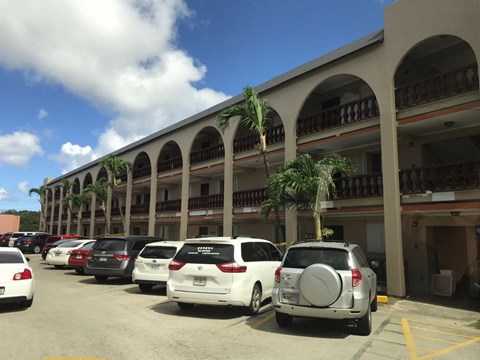 a parking lot full of cars in front of a building