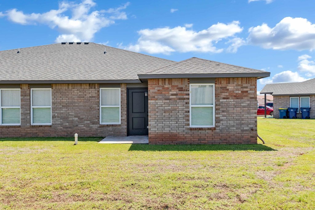 the front of a brick house with a black door