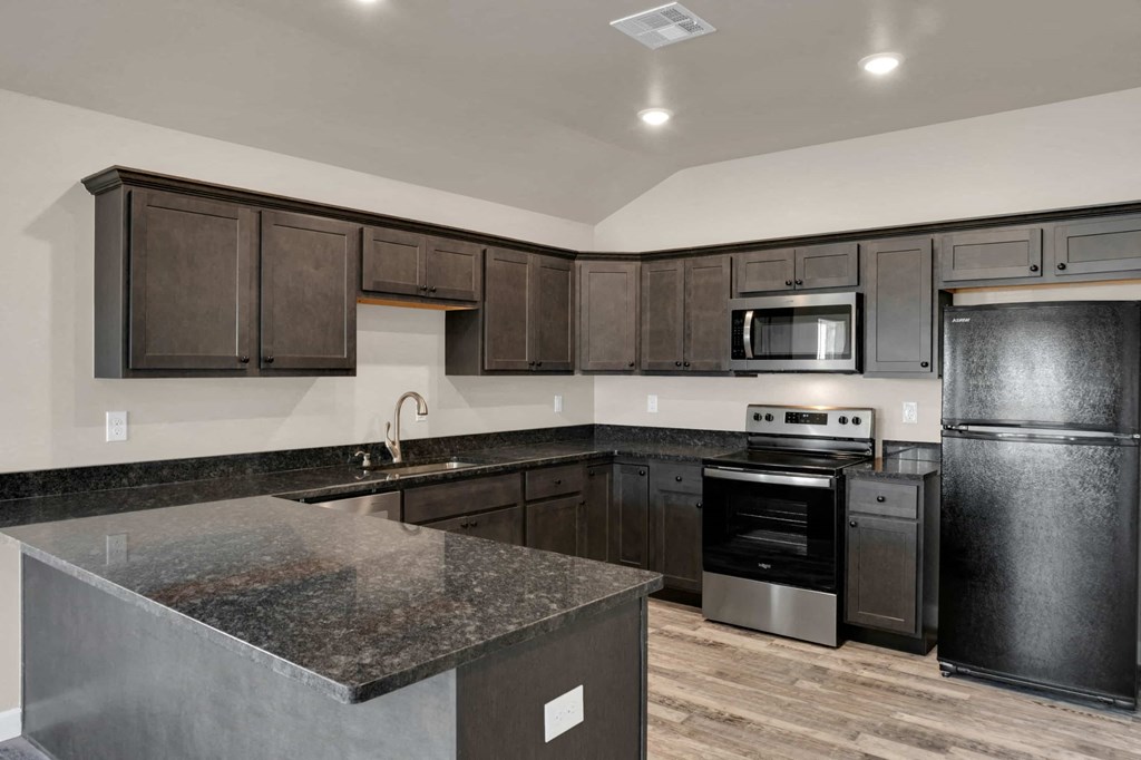 a kitchen with stainless steel appliances and granite counter tops
