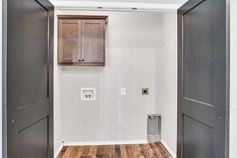 a room with white walls and black doors and a cabinet