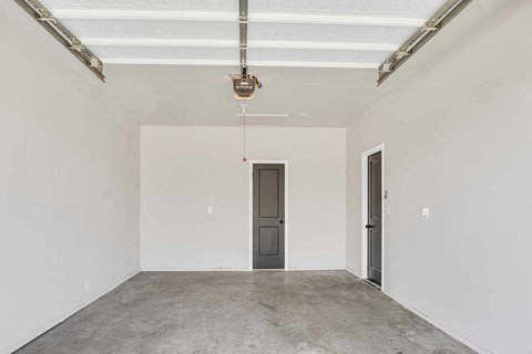 an empty room with a white wall and a door