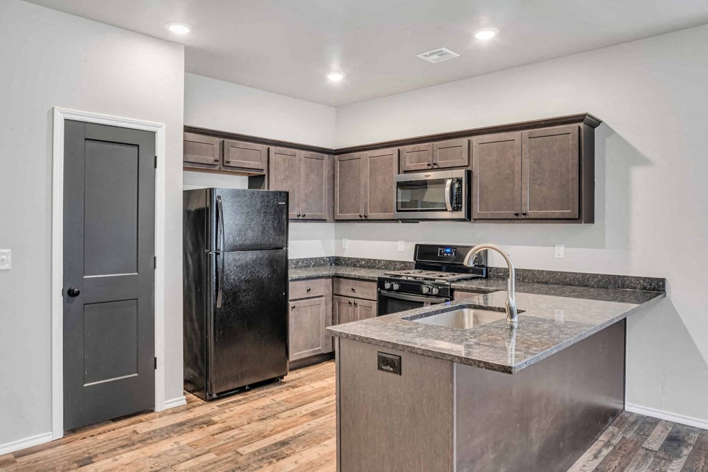 a kitchen with stainless steel appliances and wooden cabinets
