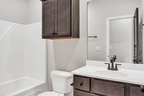 a bathroom with a sink toilet and a mirror