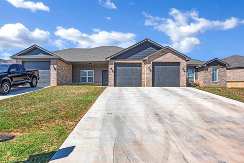 a house with a driveway and a truck in front of it