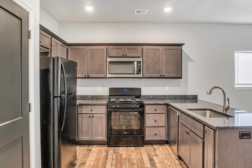 a kitchen with stainless steel appliances and wooden cabinets