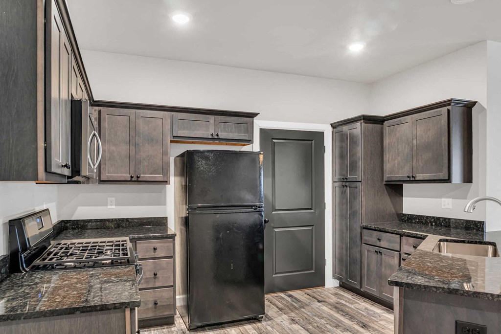 a kitchen with stainless steel appliances and wooden cabinets