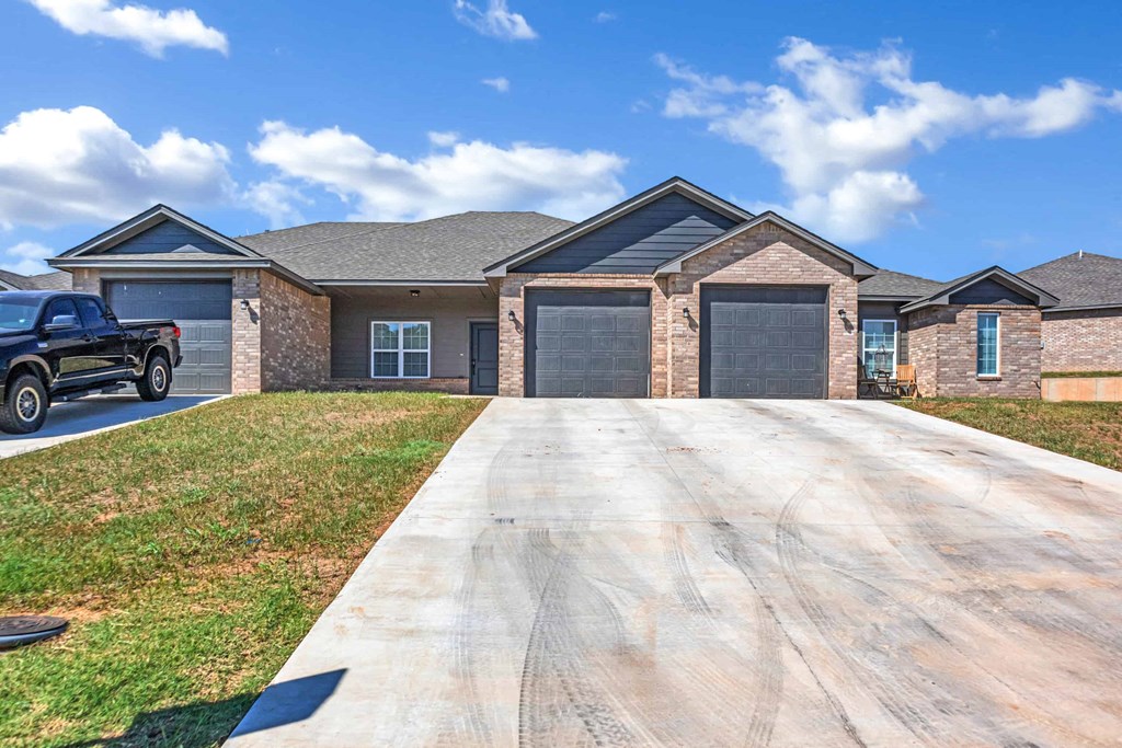 a house with a driveway and a truck in front of it